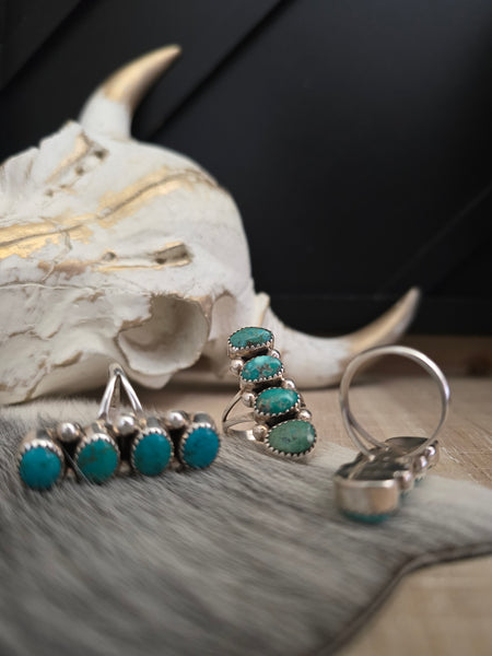 THE JOHN McCRAY FOUR TURQUOISE STONE RING